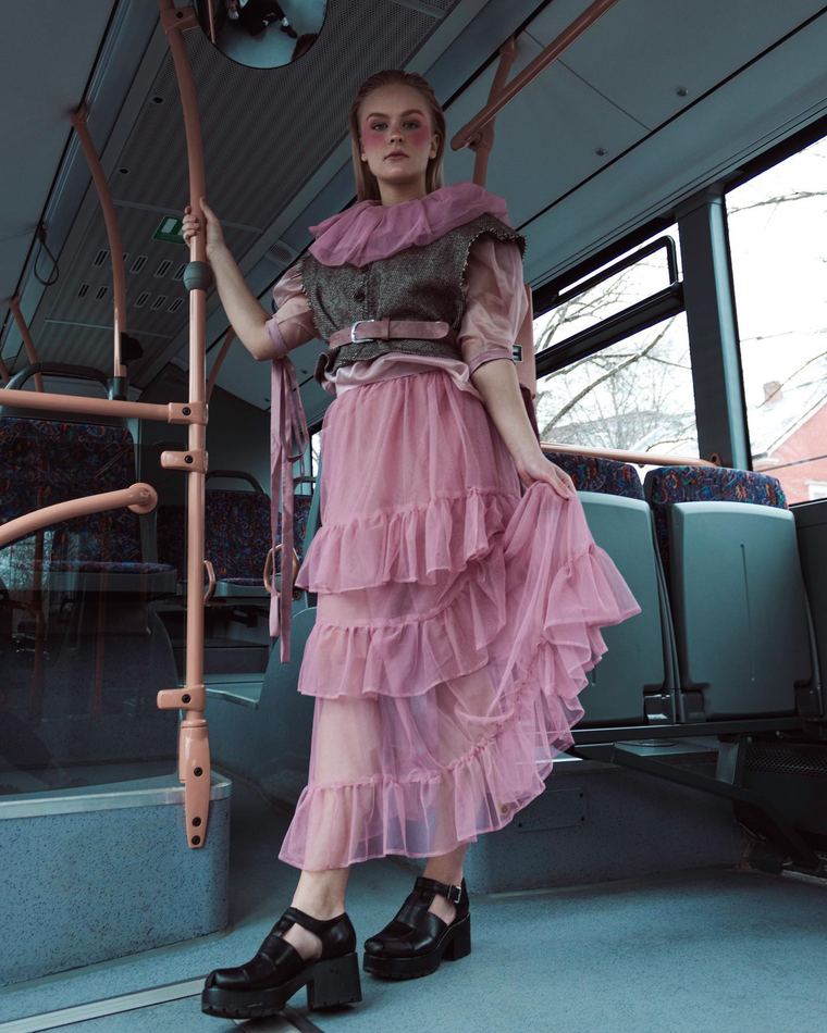 Pink tulle look standing in a bus