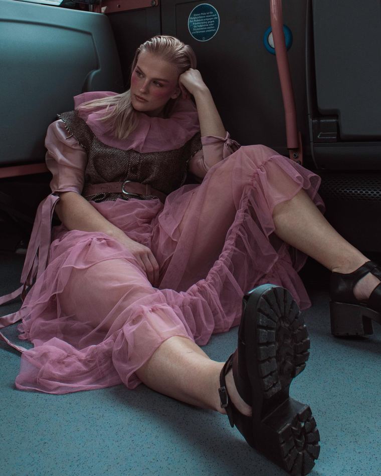 Pink tulle look sitting on the floor of a bus